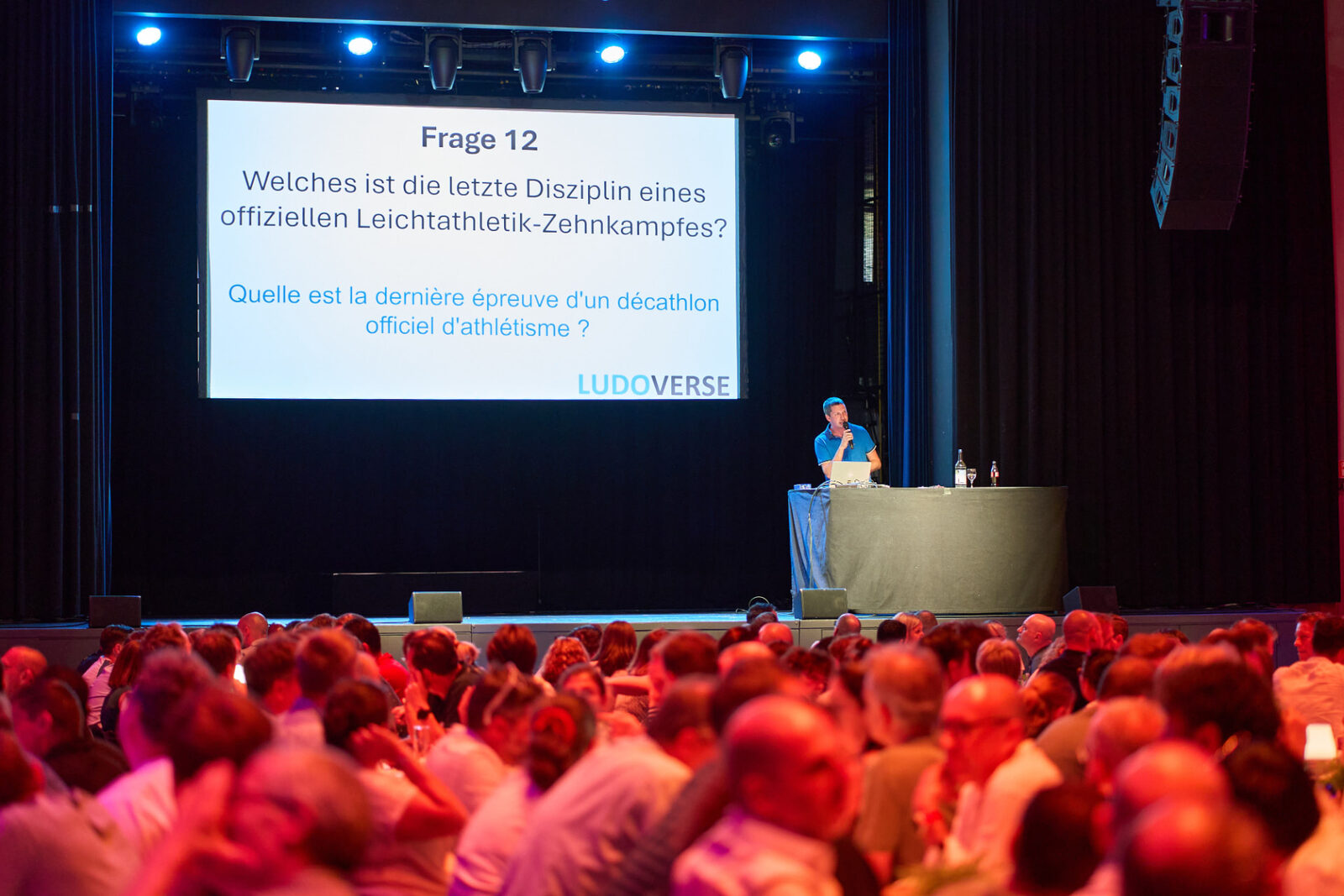 Packed audience in front of the stage during a quiz round