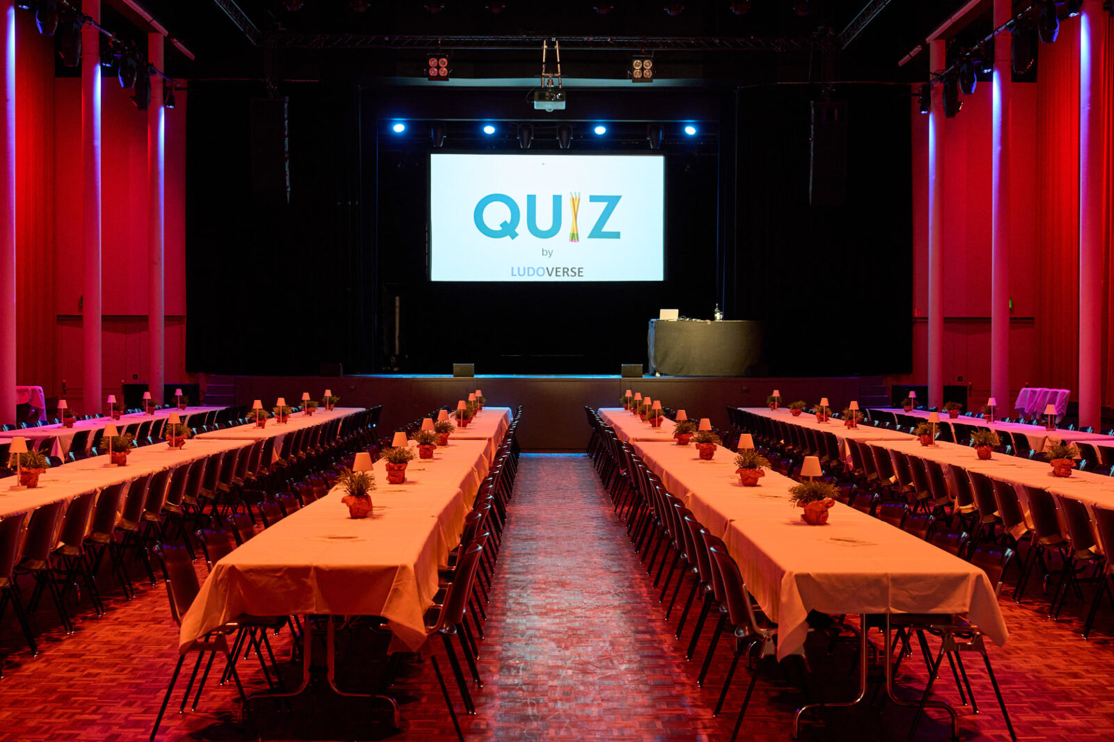 Event hall set up for a Quiz Night with a big screen