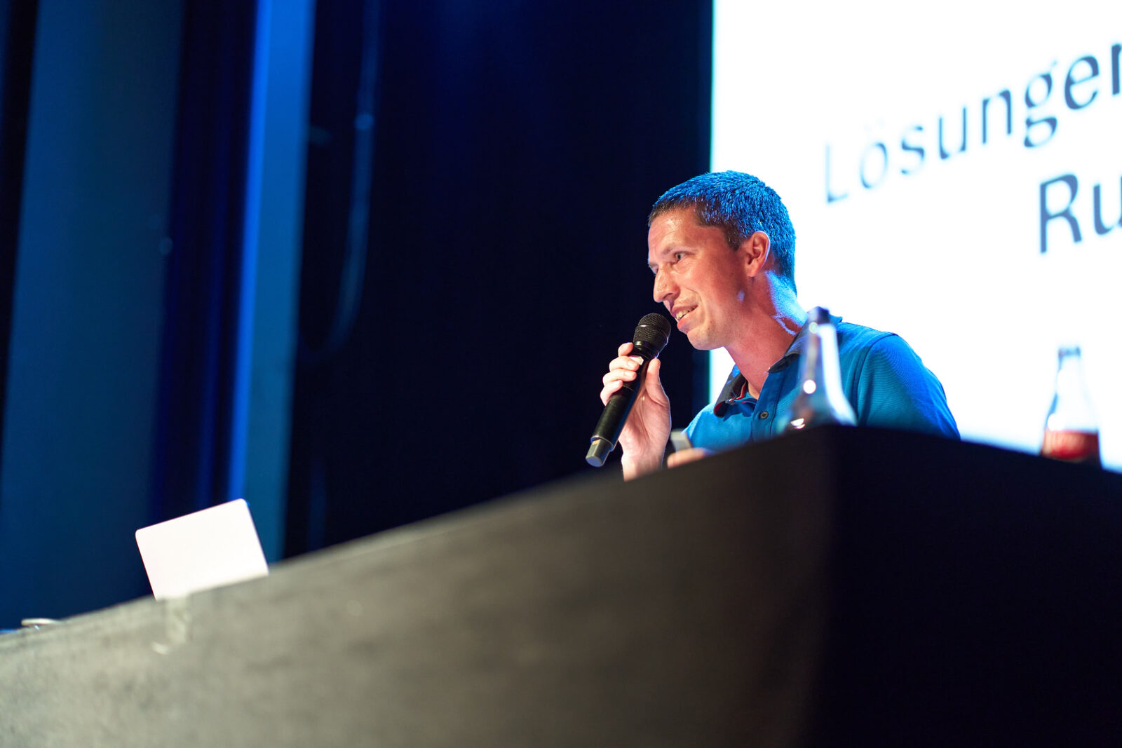 Quizmaster hosting with a microphone